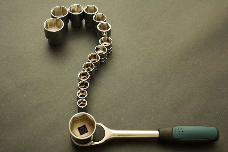 question mark made of sockets and a socket driver with a green handle for What is AGM article