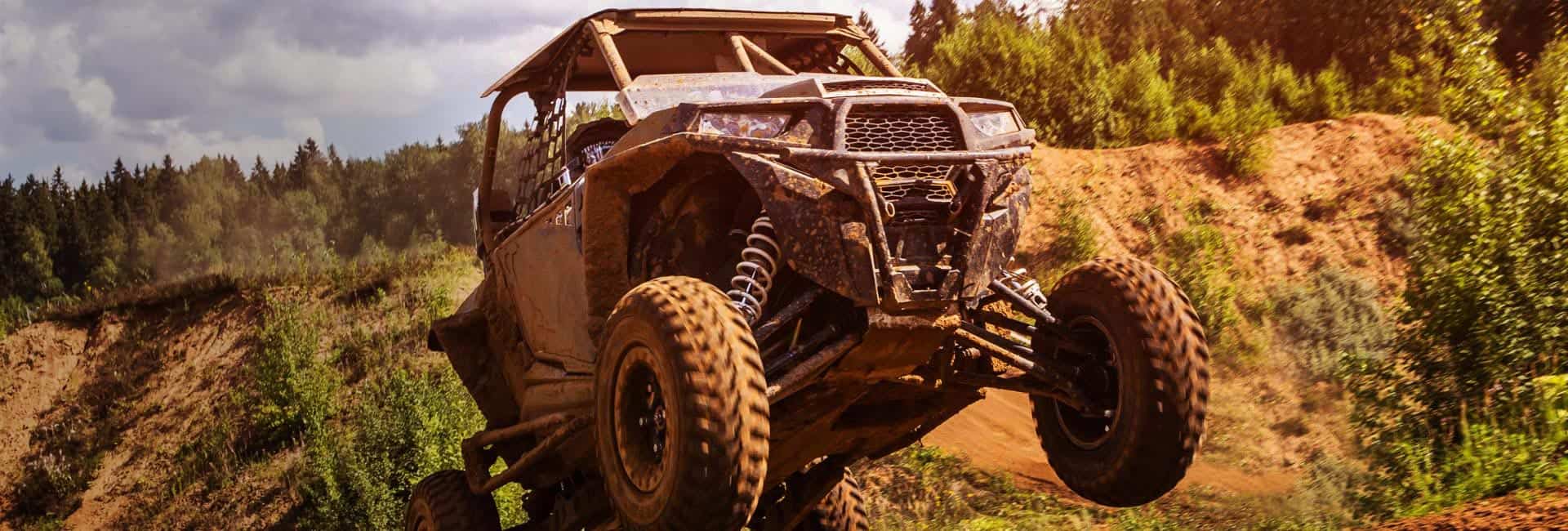 UTV flying over dirt, powered by Yuasa batteries