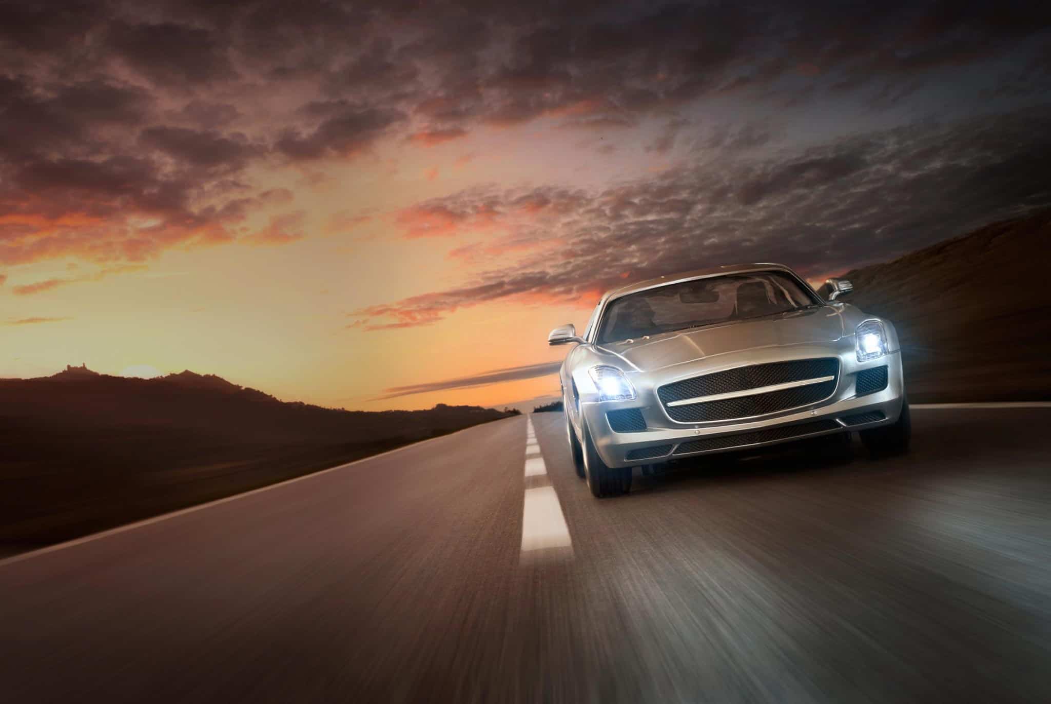 Car driving at sunset powered by Yuasa batteries
