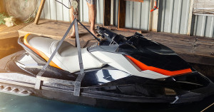 Jetski being lifted from the water for maintenance or battery replacement. 
