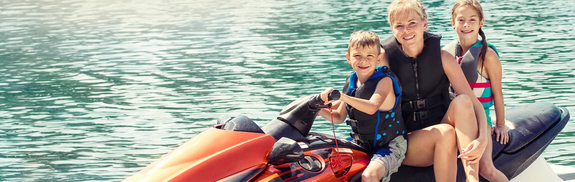Mom and her kids on a jet ski, happy they have the best battery