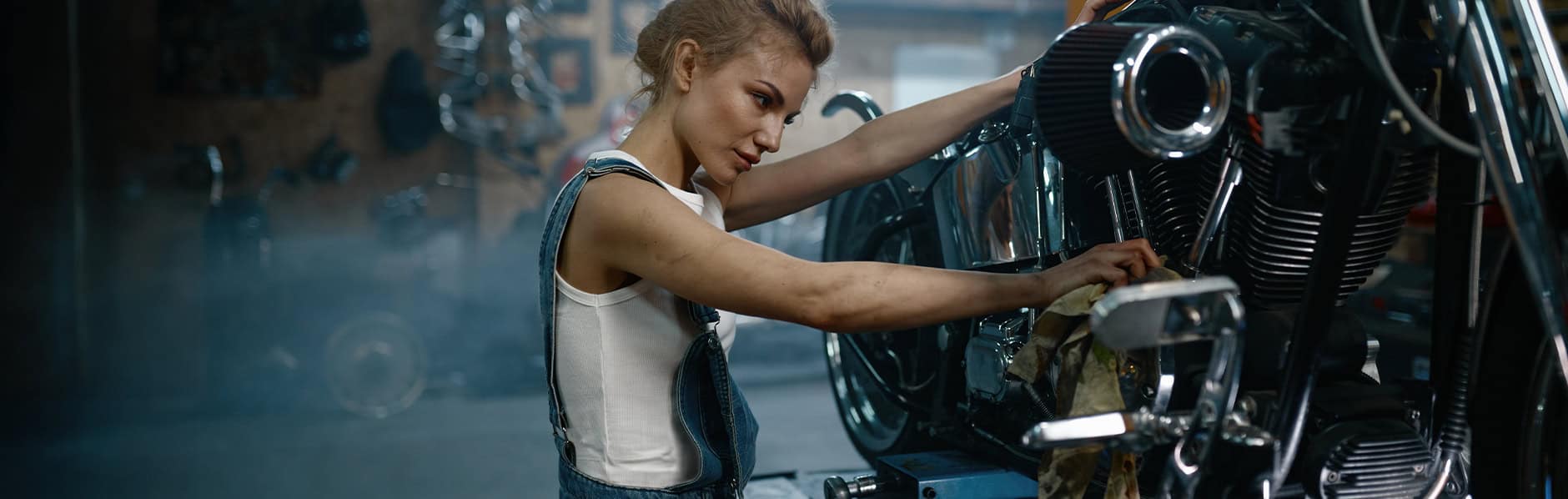 Woman works on her motorcycle installing a Yuasa GYZ upgrade