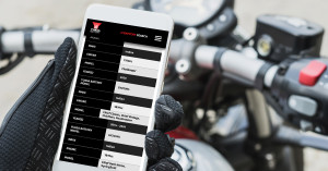 Biker looks at phone ordering a Yuasa Battery for their Indian Motorcycle.