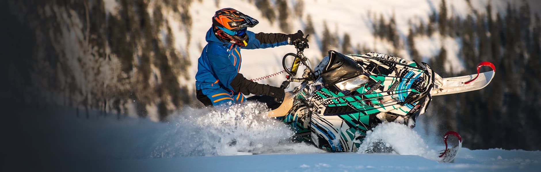 Snowmobiler enjoying fresh powder on his sled because he does winter maintenance.