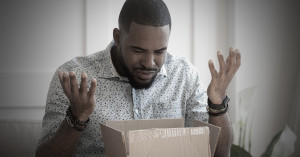 Customer is confused and upset looking into a shipping box from Amazon 