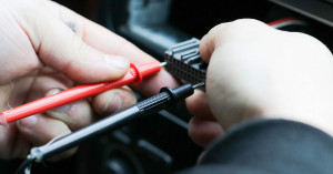 Motorcycle rider checks bike's electrical system. 