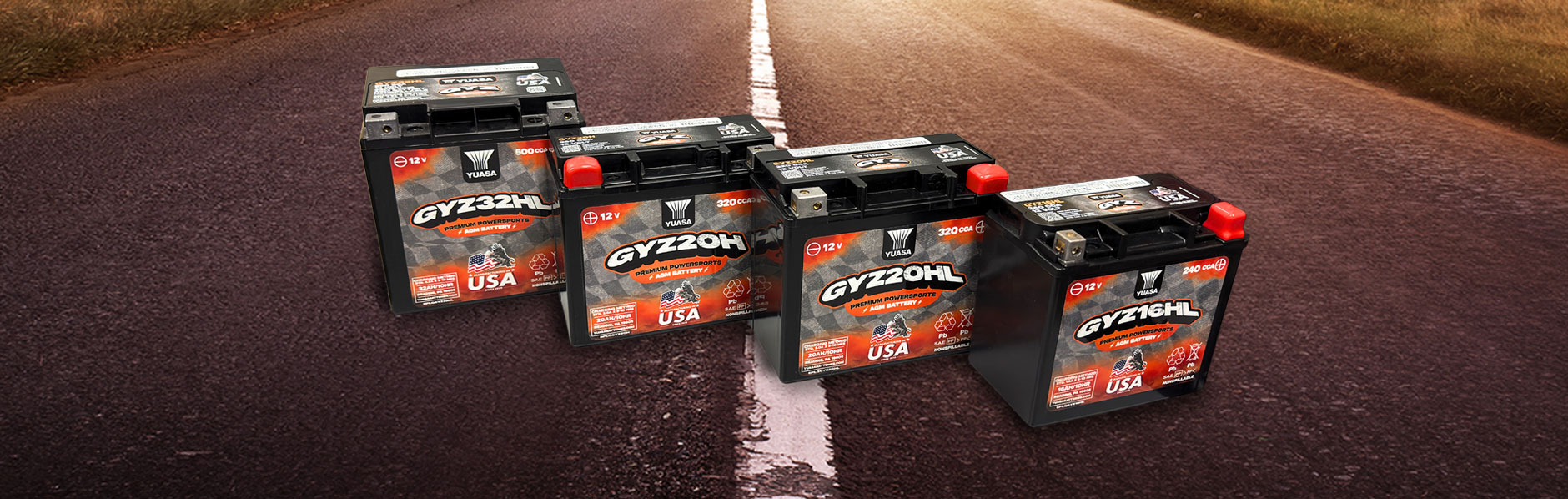 The Yuasa GYZ product lineup on over a road at sunset.