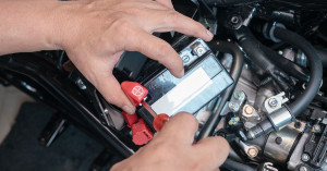 A rider's hands shown preparing their battery to charge.